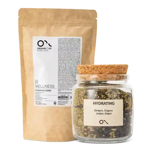 glass bottle of dried hydrating herbs for scalp treatment