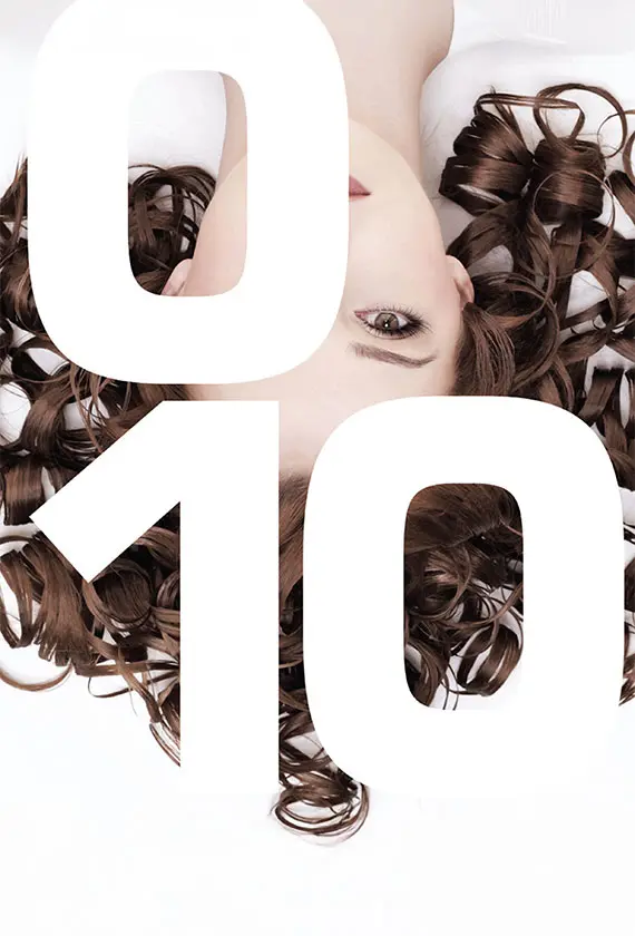 woman with curls under 010Plus Brand