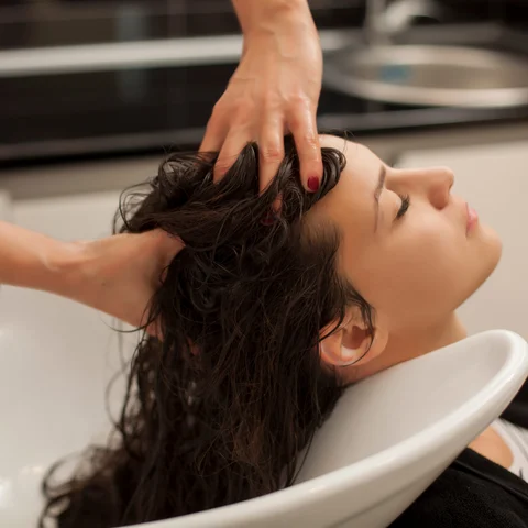 Woman having scalp treatment